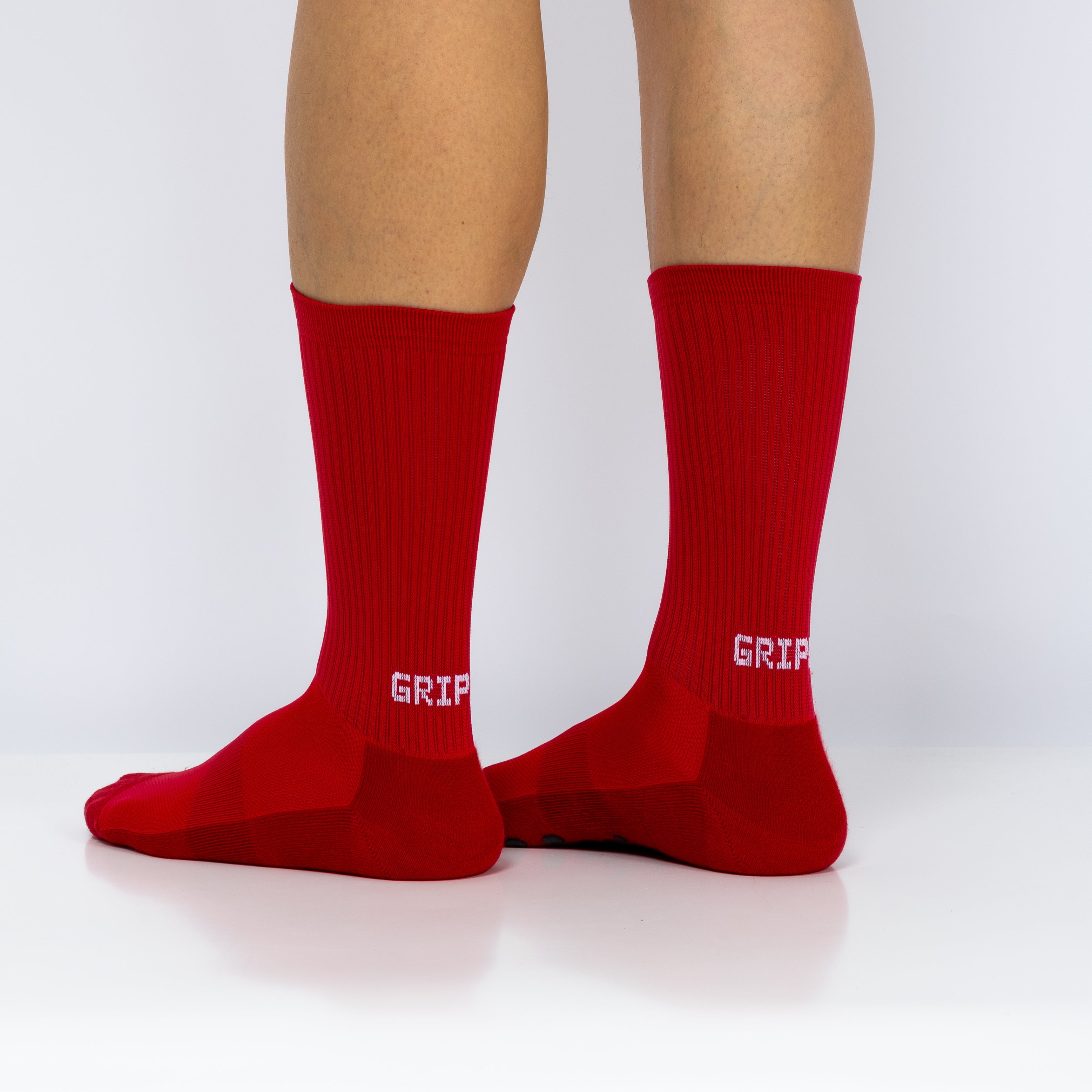Meias com antiderrapante (grip), na cor vermelha, para desporto como o futebol ou futsal..